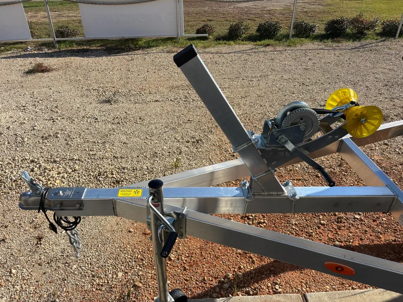 Slide: The Image of 2025 Edge Duck Boats 756DB trailer hitch and winch on gravel surface. - 32