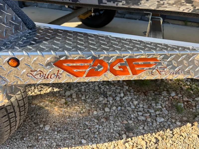 Slide: The Image of 2025 Edge Duck Boats 756DB trailer with diamond plate design and logo. - 37