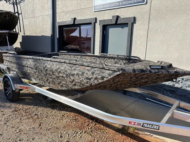 Slide: The Image of 2025 Edge Duck Boats 756DB on trailer, camo design, parked outside building. - 38