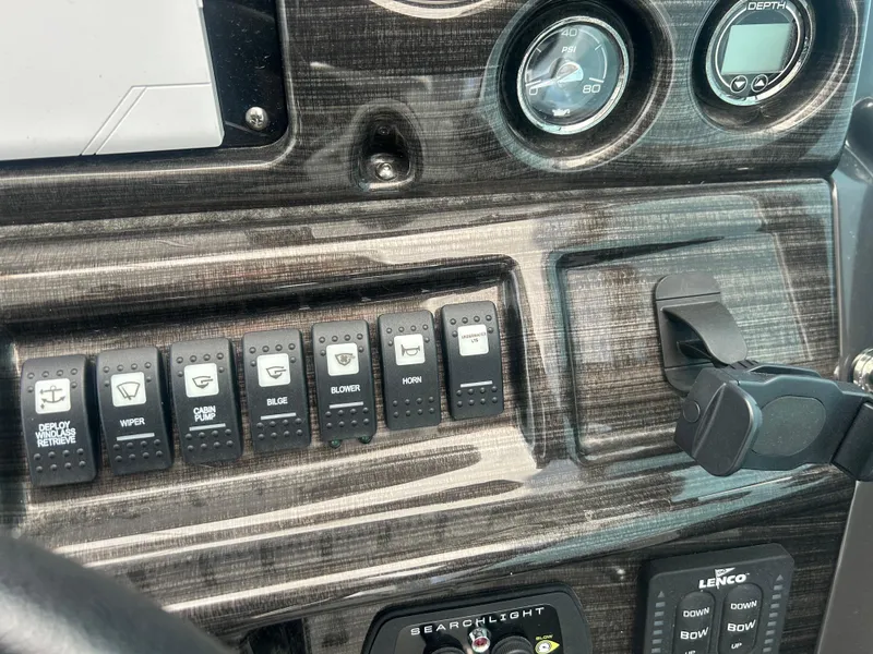 Slide: The Image of Control panel of a 2022 Monterey 295 Sport Yacht with switches and gauges. - 13