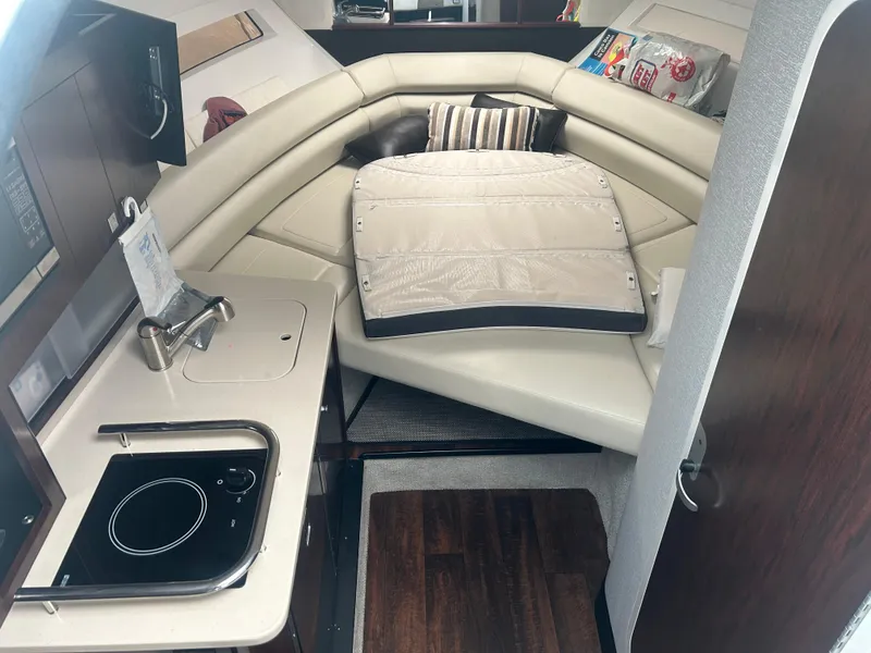 Slide: The Image of 2022 Monterey 295 Sport Yacht interior with kitchenette and seating area. - 15