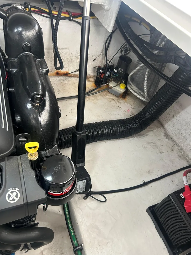 Slide: The Image of Engine compartment of 2022 Monterey 295 Sport Yacht, showing mechanical components and wiring. - 21