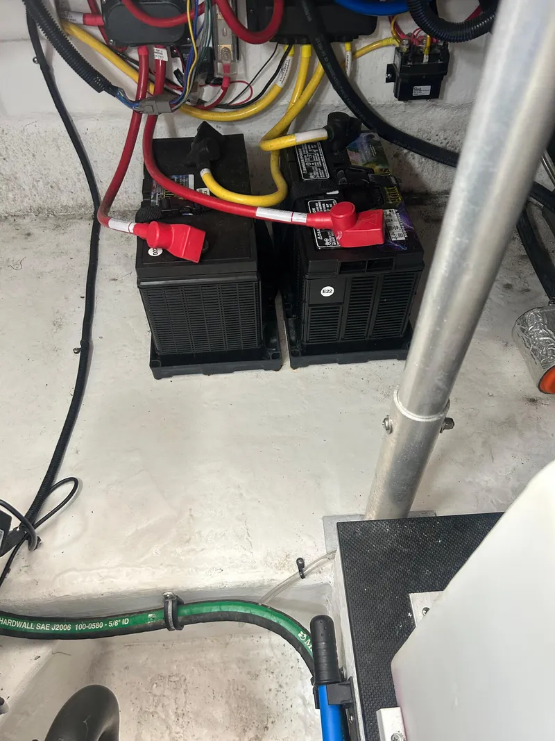 Slide: The Image of Batteries and wiring in 2022 Monterey 295 Sport Yacht engine compartment. - 22