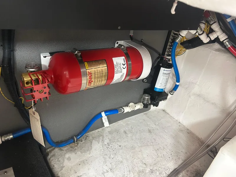 Slide: The Image of Engine compartment of 2022 Monterey 295 Sport Yacht with fire extinguisher and plumbing. - 6