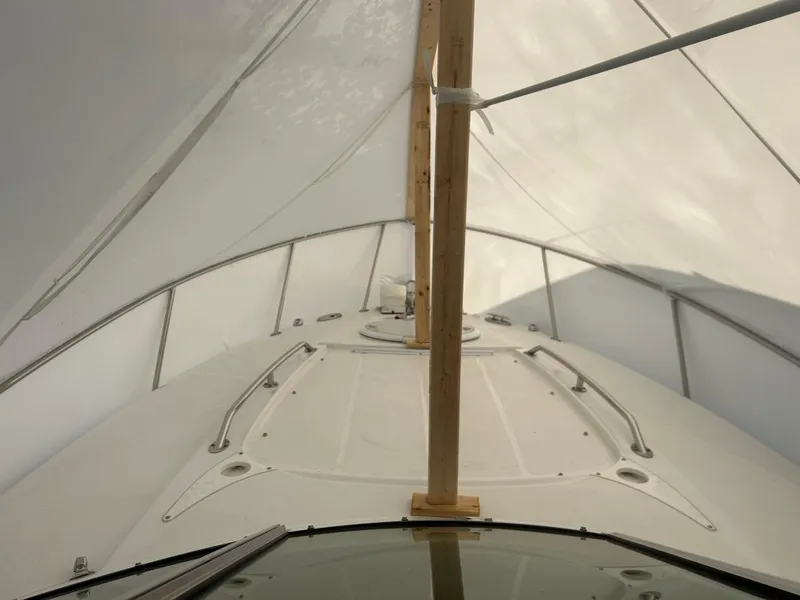 Slide: The Image of 2022 Monterey 295 Sport Yacht under protective cover, showcasing deck and railings. - 9