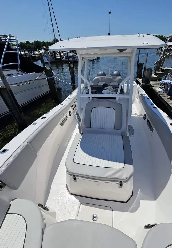 Slide: The Image of 2023 Sea Fox 268 Commander boat docked at marina, showcasing spacious seating and sleek design. - 3