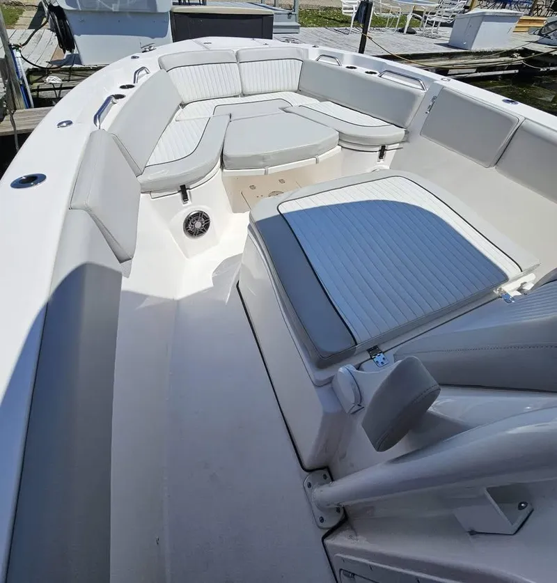 Slide: The Image of 2023 Sea Fox 268 Commander boat interior with cushioned seating and spacious deck. - 5