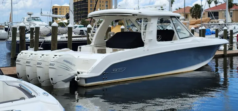 Slide: The Image of 2019 Boston Whaler 380 Realm boat docked at marina with multiple outboard engines. - 5