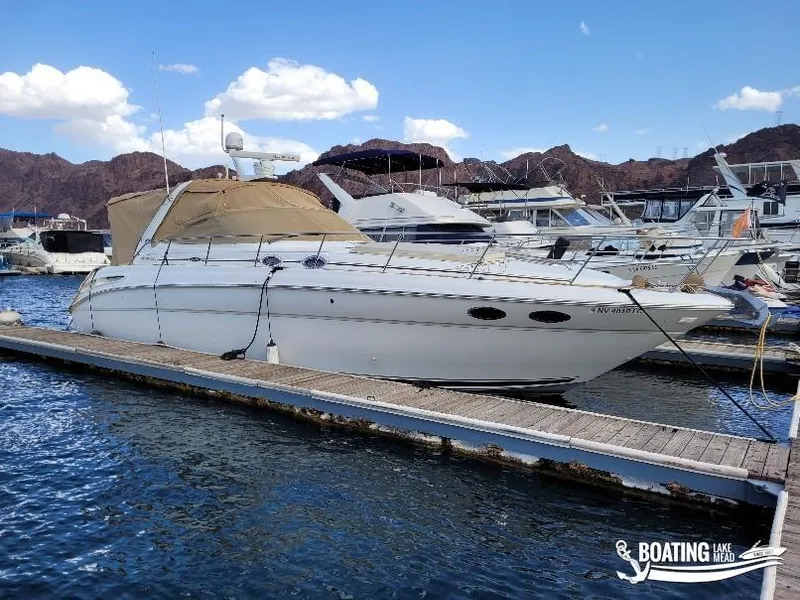 Slide: The Image of 2003 Sea Ray 380 Sundancer yacht docked at marina, clear sky, mountainous backdrop. - 10