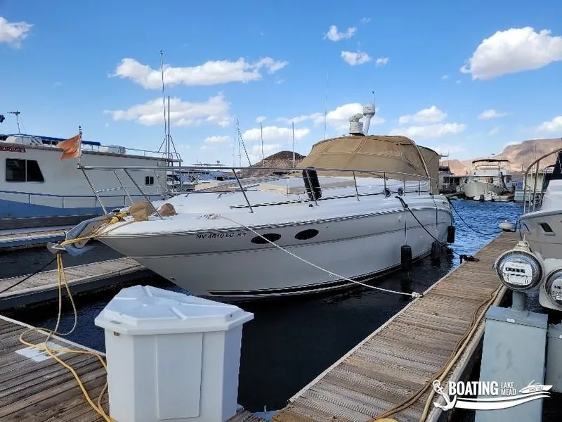 Slide: The Image of 2003 Sea Ray 380 Sundancer docked at marina under blue sky. - 11