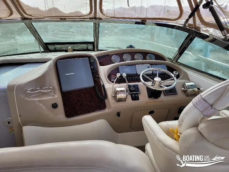 Slide: The Image of Interior helm of 2003 Sea Ray 380 Sundancer yacht with steering wheel and controls. - 13