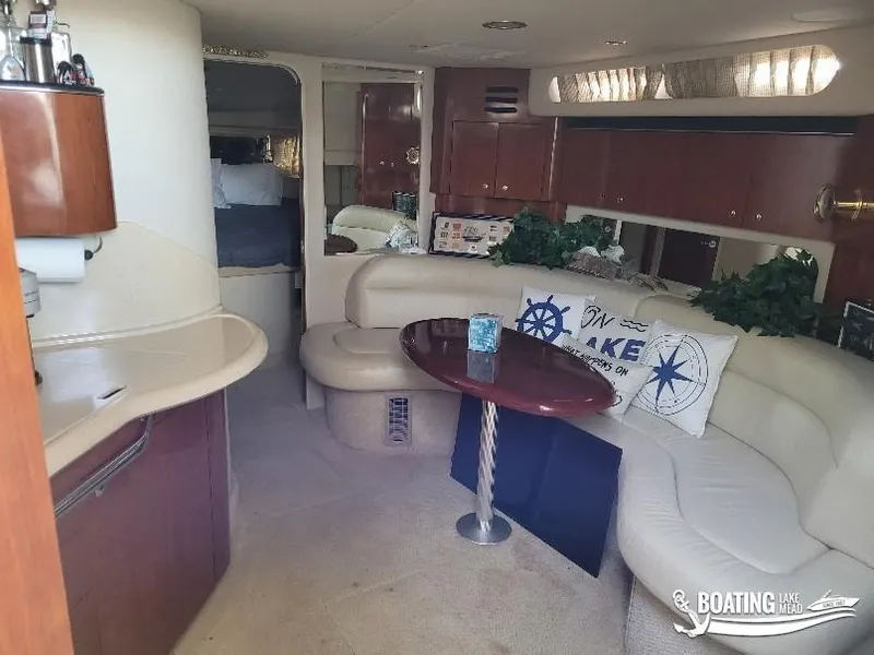 Slide: The Image of Interior of 2003 Sea Ray 380 Sundancer yacht with plush seating and elegant decor. - 14