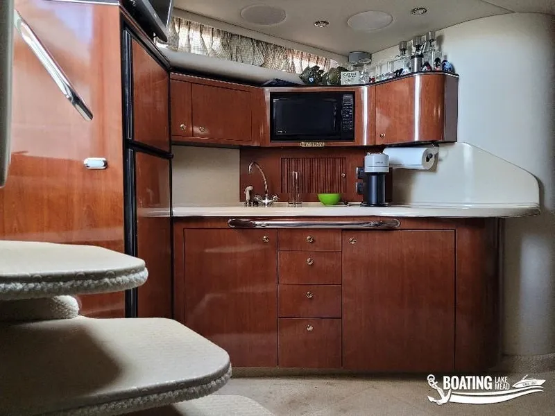 Slide: The Image of Interior of 2003 Sea Ray 380 Sundancer yacht kitchen with wood cabinetry and appliances. - 15