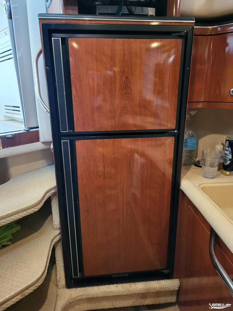 Slide: The Image of Wood-paneled refrigerator in 2003 Sea Ray 380 Sundancer yacht interior. - 16