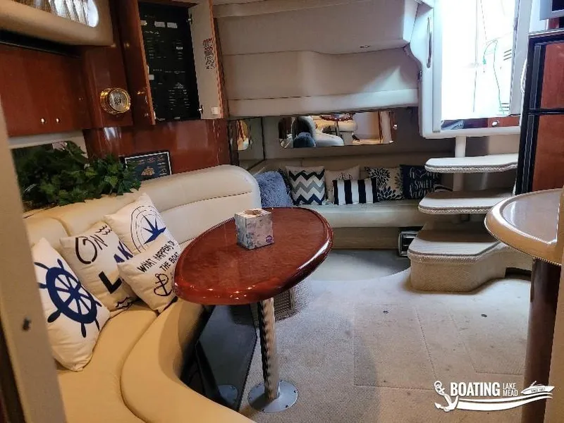 Slide: The Image of Interior of 2003 Sea Ray 380 Sundancer with cozy seating and nautical decor. - 18