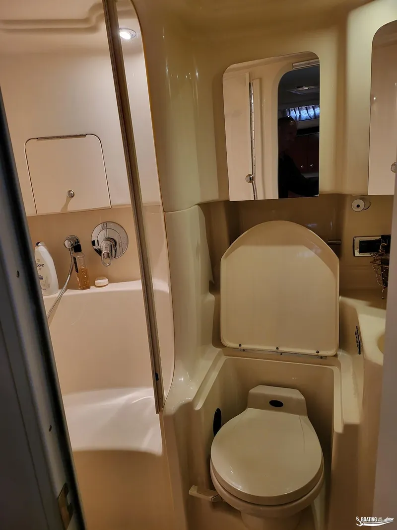 Slide: The Image of Bathroom interior of 2003 Sea Ray 380 Sundancer yacht, featuring toilet and shower. - 19
