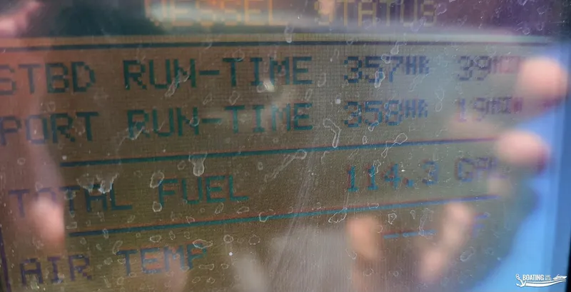 Slide: The Image of Close-up of Sea Ray 380 Sundancer 2003 vessel status display showing run-time and fuel data. - 22