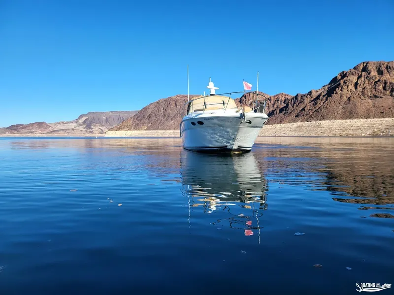 Slide: The Image of 2003 Sea Ray 380 Sundancer on calm water with mountainous backdrop. - 5