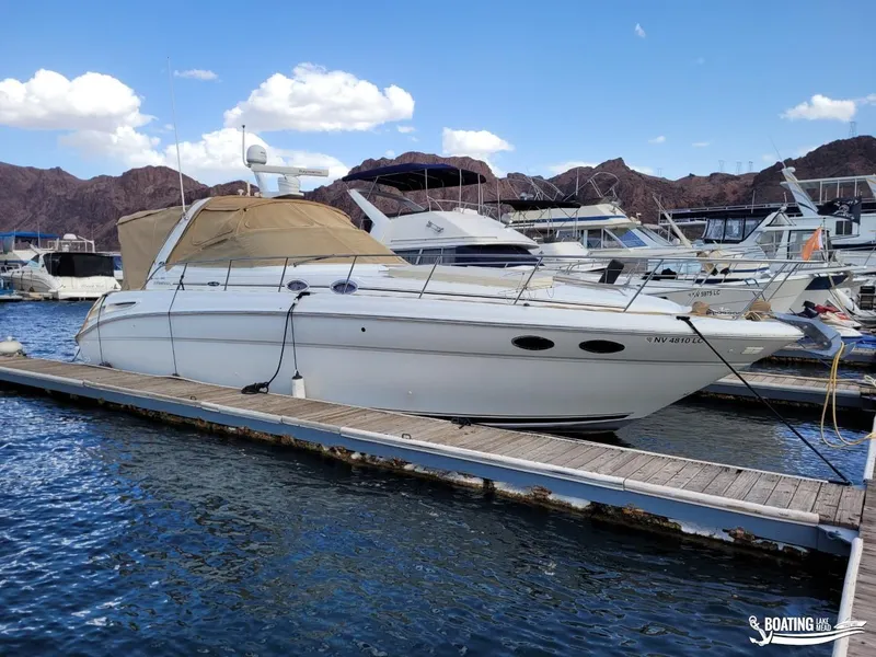 Slide: The Image of 2003 Sea Ray 380 Sundancer docked at marina with scenic mountain backdrop. - 8