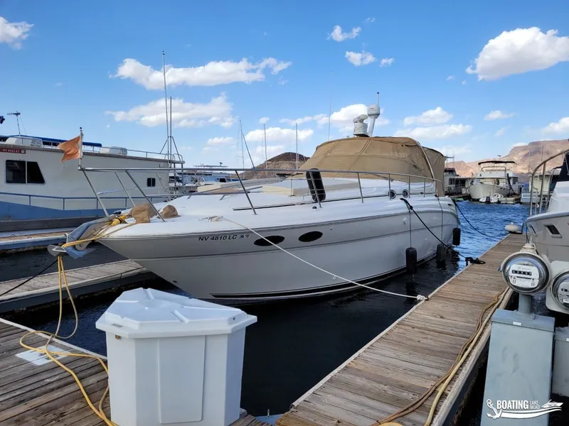 Slide: The Image of 2003 Sea Ray 380 Sundancer docked at marina under blue sky. - 9