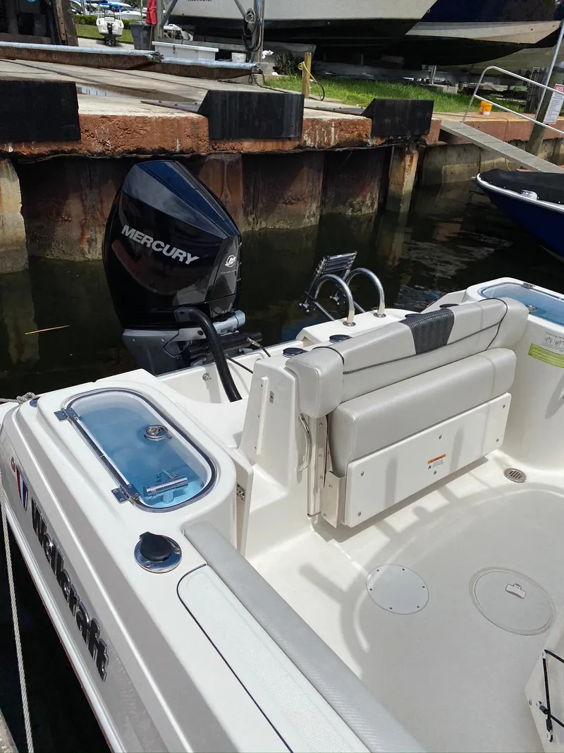 Slide: The Image of 2019 Wellcraft 242 Fisherman boat with Mercury engine docked at marina. - 16