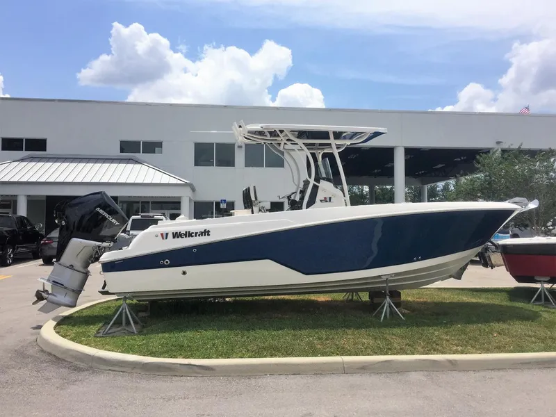 Slide: The Image of 2019 Wellcraft 242 Fisherman boat displayed outdoors on stands. - 23