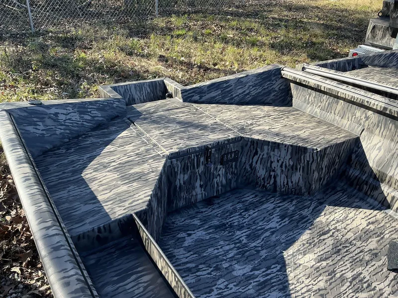 Slide: The Image of 2025 Reaper Boats 656 STEP TRANSOM MID DECK with camouflage pattern, outdoor setting. - 3