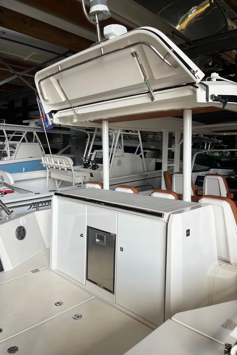 Slide: The Image of 2018 Axopar 370 SUN TOP boat interior with storage and seating area. - 13