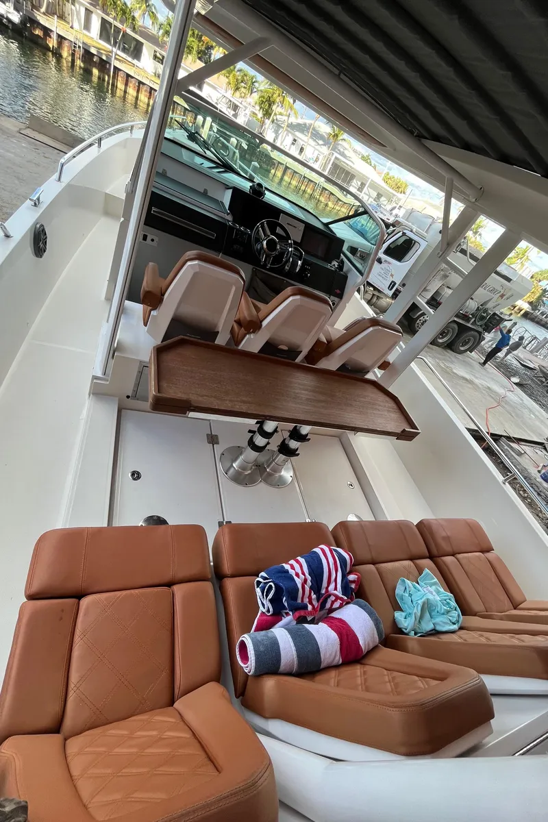 Slide: The Image of 2018 Axopar 370 SUN TOP boat with tan seats and folding table . - 22