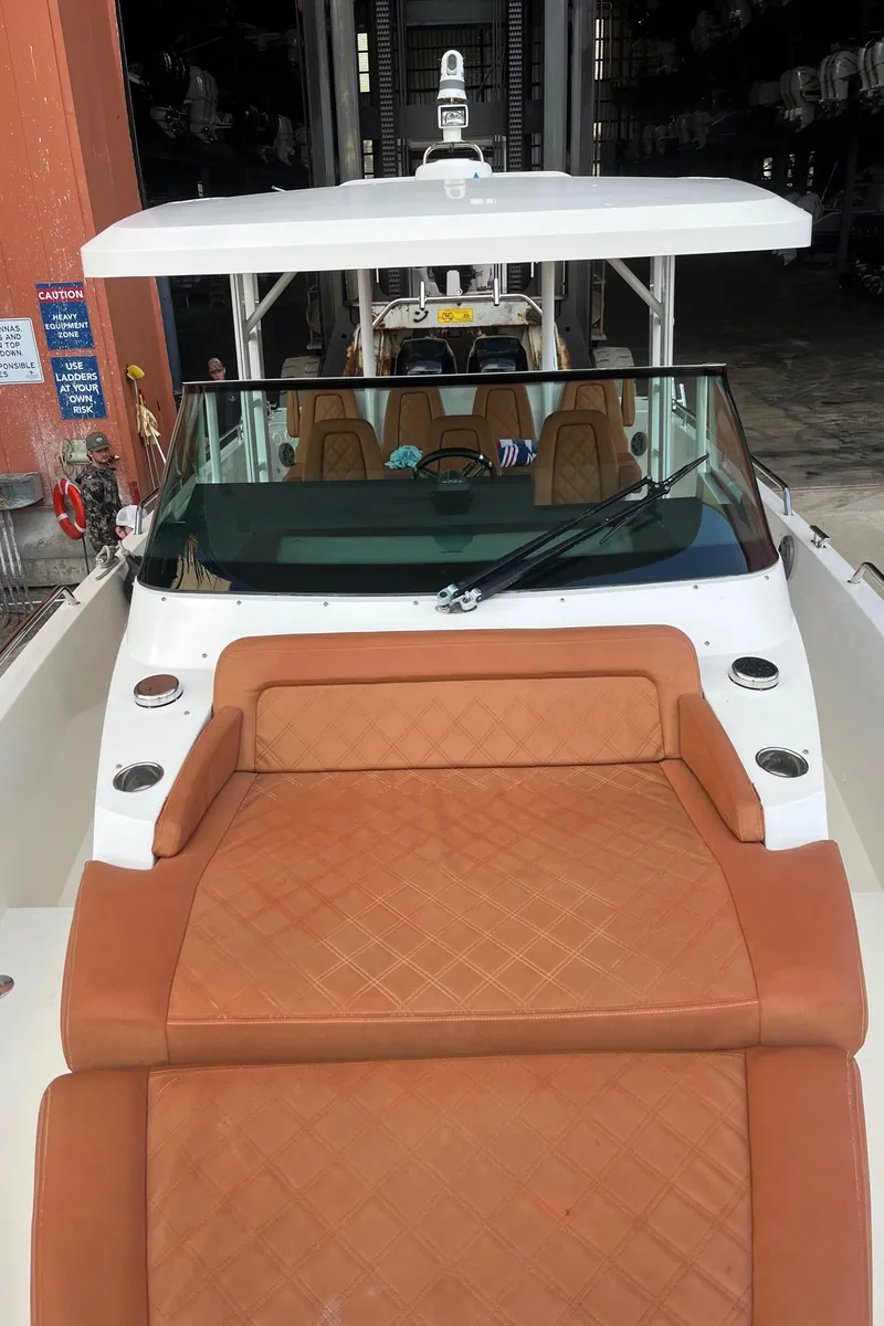 Slide: The Image of 2018 Axopar 370 SUN TOP boat with sun lounge pad/seating and sleek design. - 23