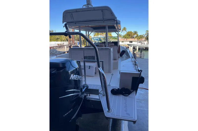 Slide: The Image of 2018 Axopar 370 SUN TOP boat with Mercury engine, docked near palm trees. - 25