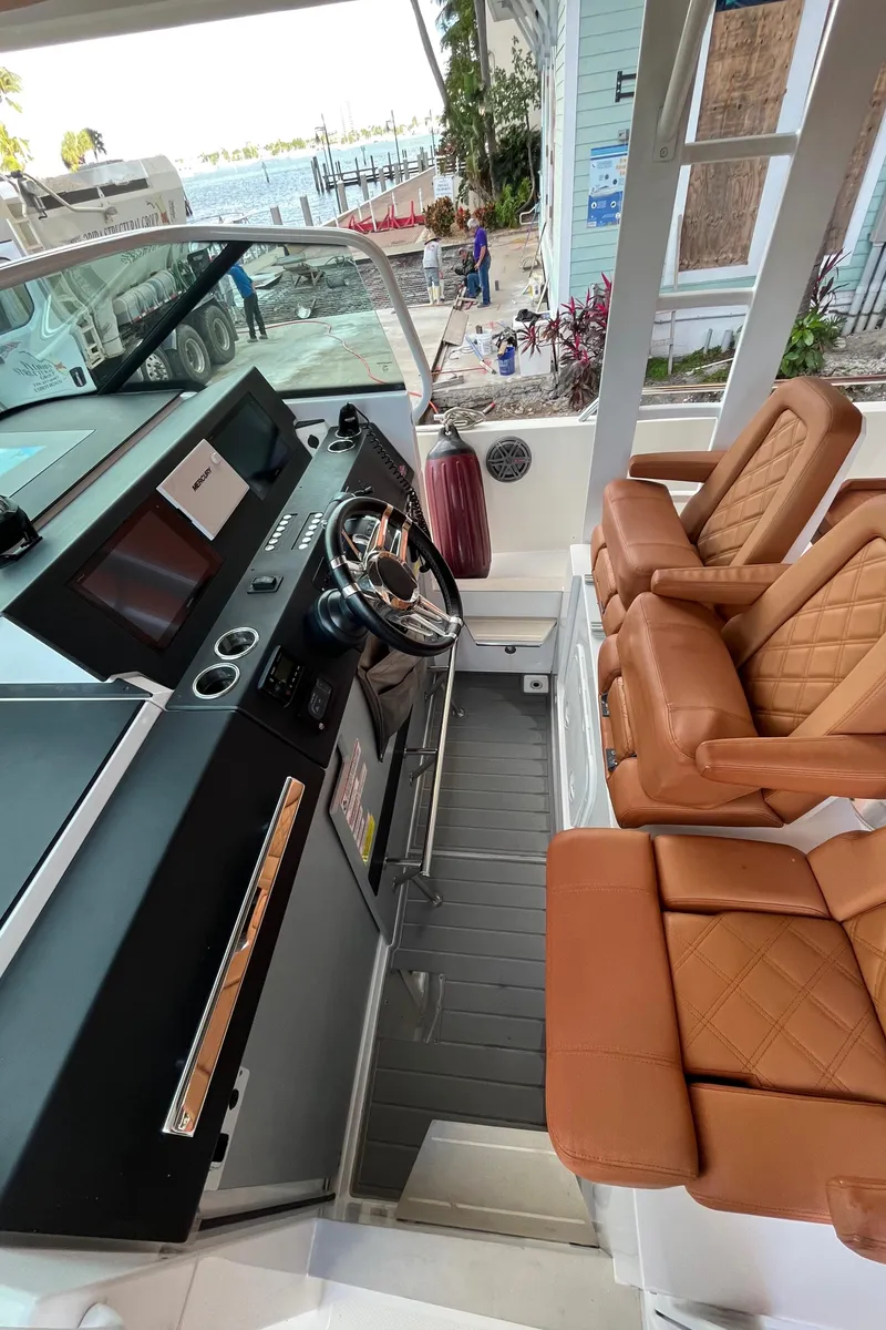 Slide: The Image of 2018 Axopar 370 SUN TOP boat interior with Bentley styled upholstered seats and modern dashboard. - 6
