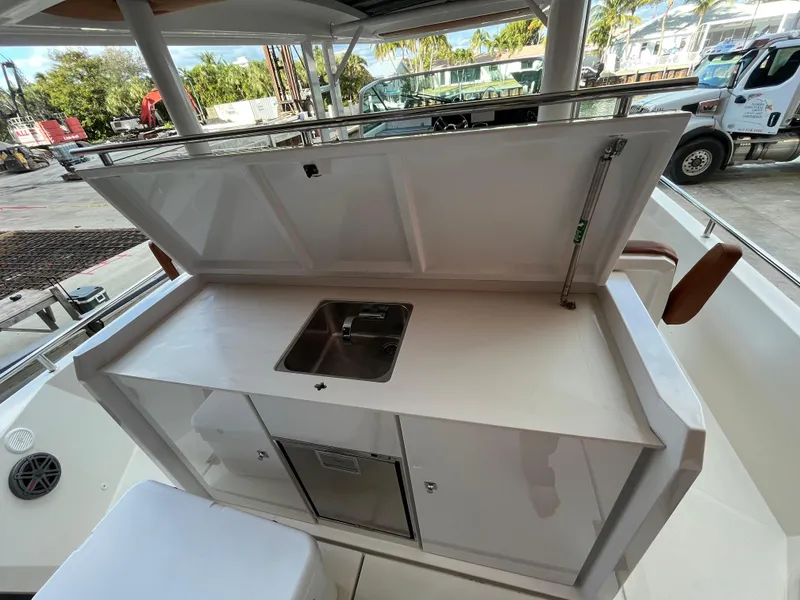 Slide: The Image of 2018 Axopar 370 SUN TOP boat kitchenette with sink and storage. - 7