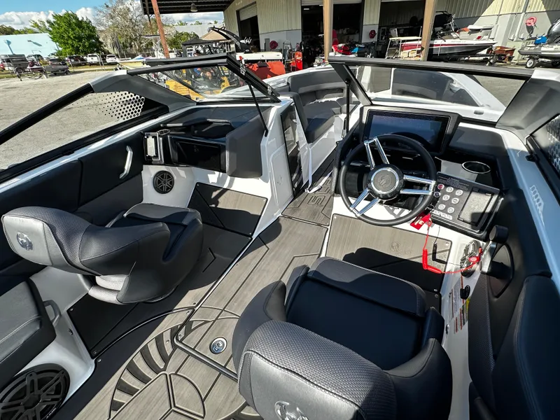 Slide: The Image of 2024 Scarab 235 Wake ID boat interior with modern dashboard and seating. - 10