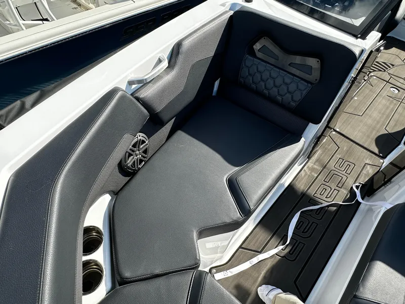Slide: The Image of 2024 Scarab 235 Wake ID boat interior with black seating and cup holders. - 17