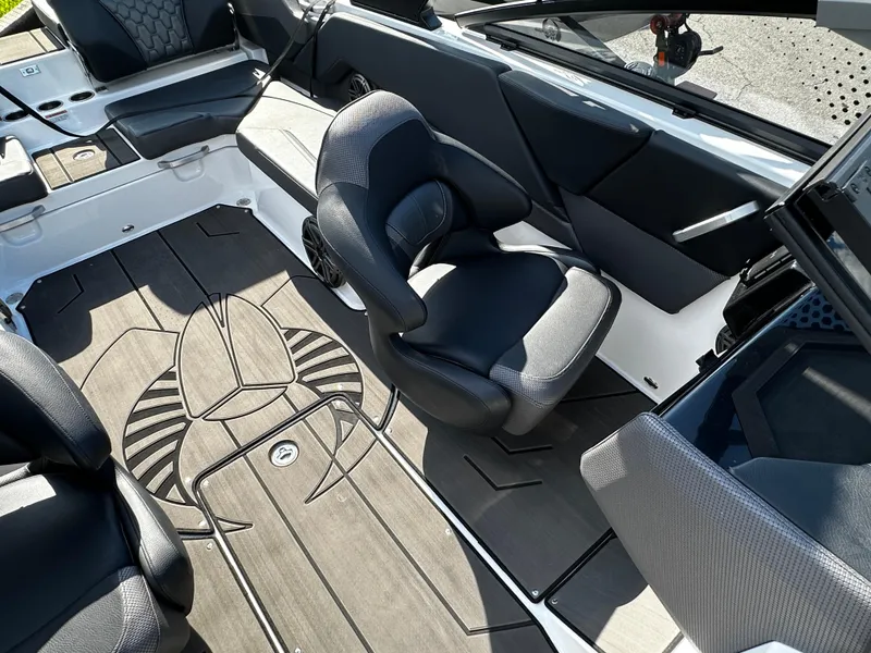 Slide: The Image of 2024 Scarab 235 Wake ID boat interior with sleek seating and stylish flooring design. - 21