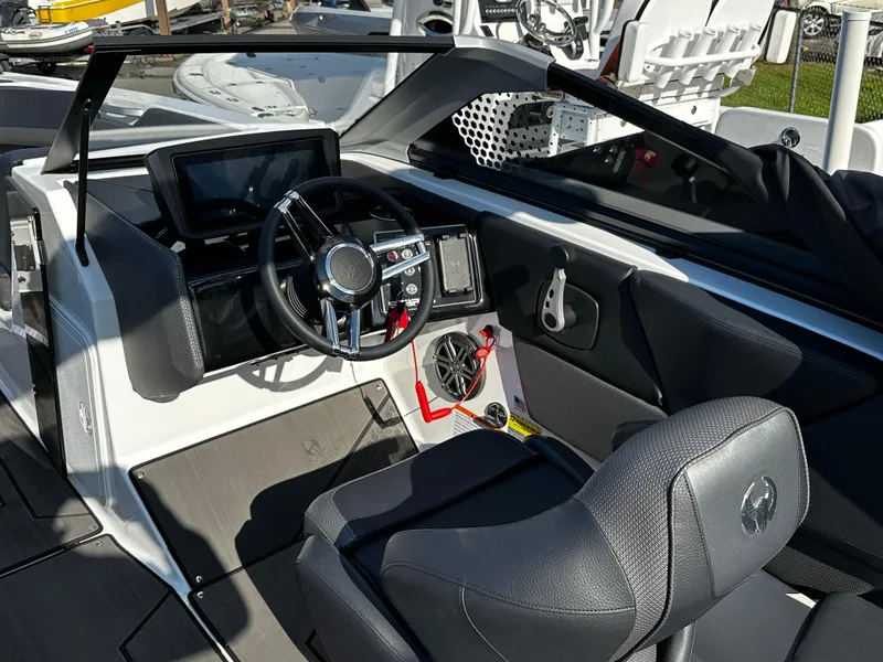 Slide: The Image of 2024 Scarab 235 Wake ID boat interior with modern dashboard and steering wheel. - 23