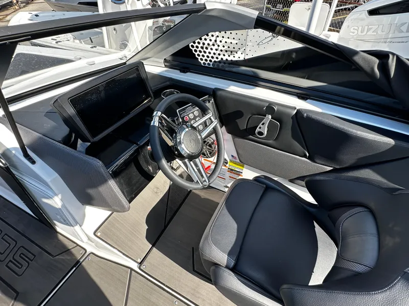 Slide: The Image of 2024 Scarab 235 Wake ID boat interior with modern steering and dashboard controls. - 24