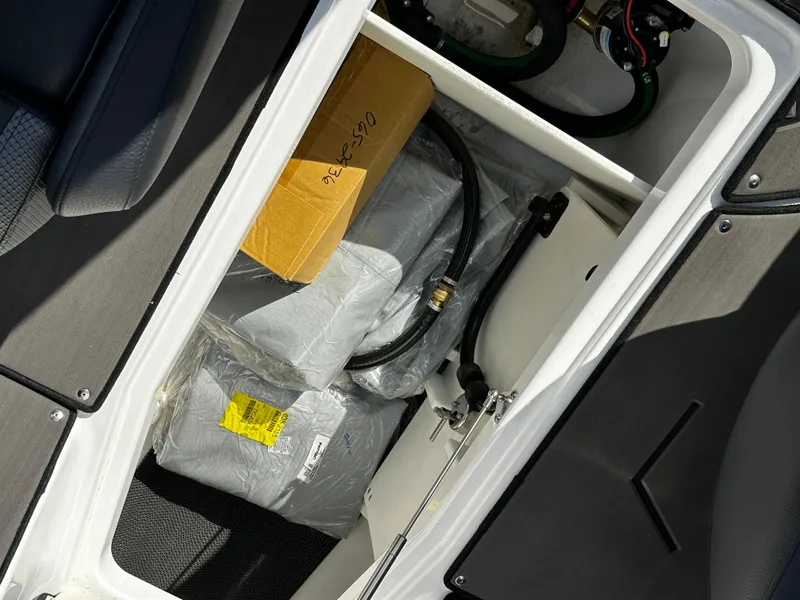 Slide: The Image of 2024 Scarab 235 Wake ID storage compartment with equipment and wiring. - 34