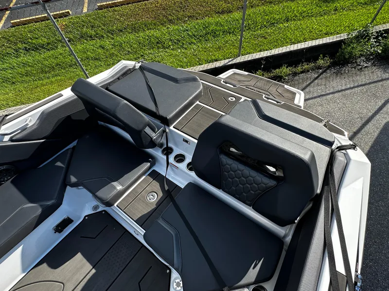 Slide: The Image of 2024 Scarab 235 Wake ID boat interior with sleek black seating and modern design. - 39