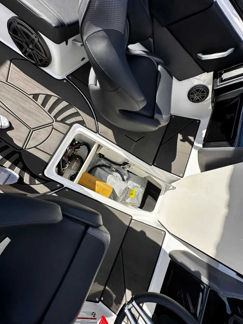 Slide: The Image of 2024 Scarab 235 Wake ID interior with open storage compartment and seating. - 40