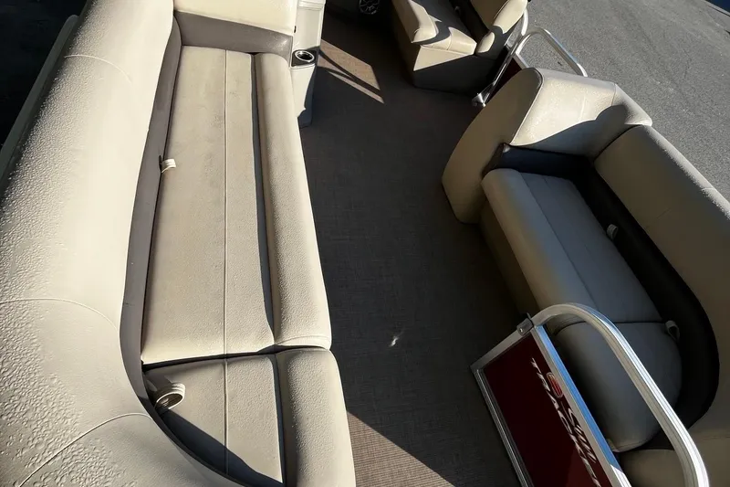 Slide: The Image of 2025 Sun Tracker Party Barge 18 DLX interior with beige seating and spacious layout. - 5