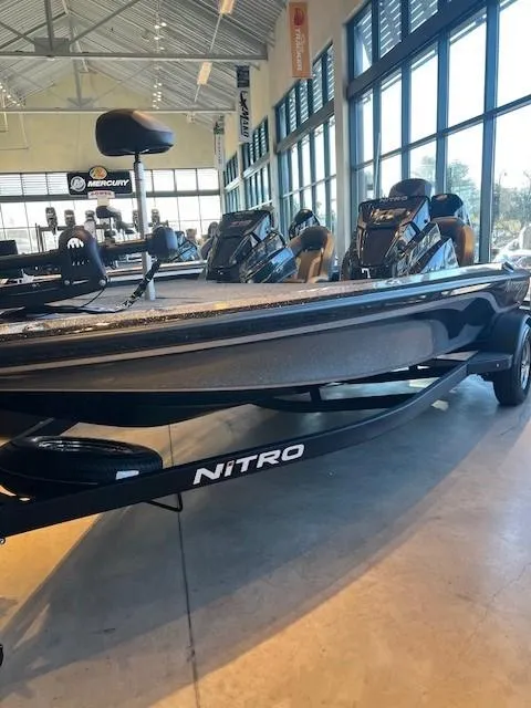 The Image of 2025 Nitro Z19 boat on trailer in parking lot, sunny day. - 0