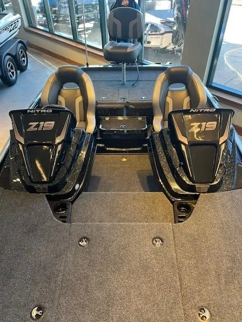 Slide: The Image of 2025 Nitro Z19 boat parked outside a boat service center. - 2