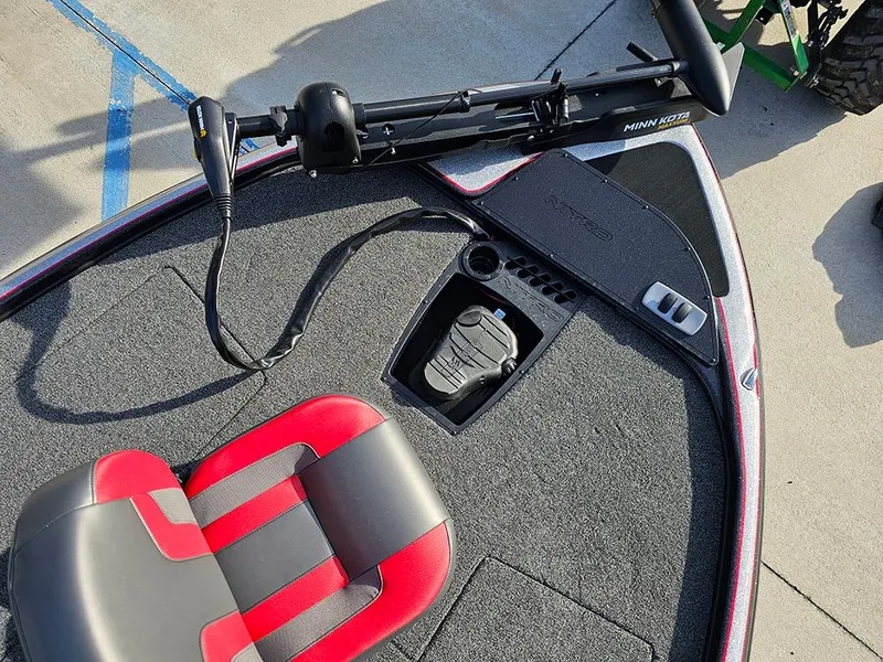 Slide: The Image of 2025 Nitro Z18 boat deck with red and gray seat, trolling motor, and foot pedal. - 26