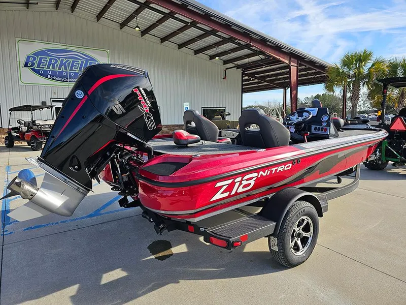 Slide: The Image of 2025 Nitro Z18 boat in red, parked outdoors with a powerful outboard motor. - 3