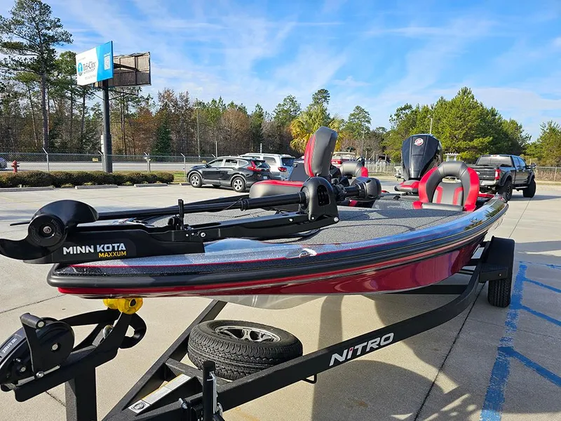 Slide: The Image of 2025 Nitro Z18 boat with Minn Kota motor on trailer, parked outdoors. - 5