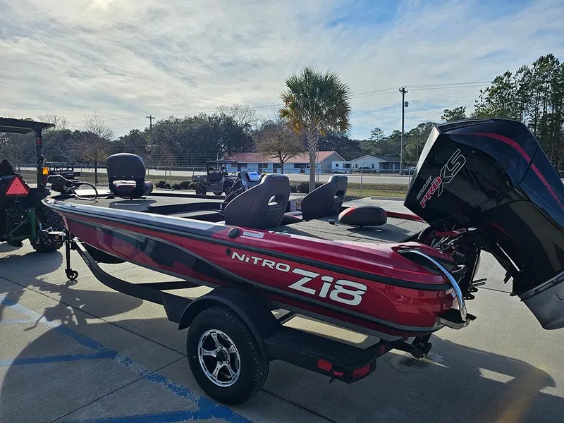 Slide: The Image of 2025 Nitro Z18 boat with trailer, parked outdoors on a sunny day. - 7