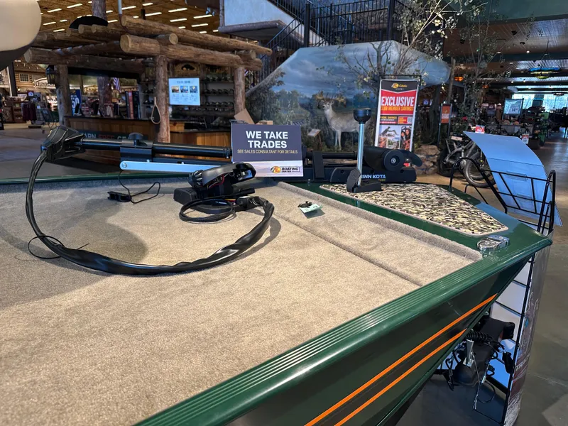 Slide: The Image of 2025 Tracker Bass Tracker Classic Limited boat on display in a showroom. - 3