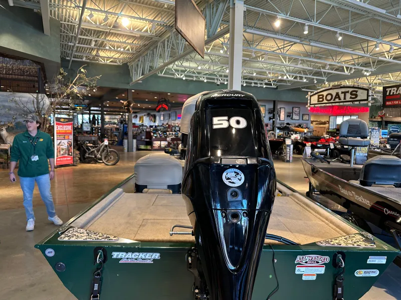 Slide: The Image of 2025 Tracker Bass Tracker Classic Limited boat displayed in showroom with 50 HP engine. - 4